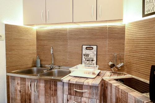 a kitchen with a sink and a counter top at Apartman Darija 3 in Gornji Orahovac