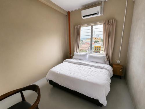 a small bedroom with a bed and a window at Astrid Lofts in Ipoh