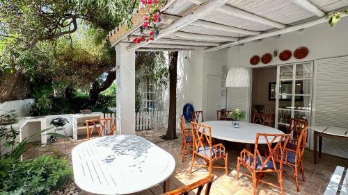 a patio with a white table and chairs at Dunas - Private Pool - 8 Guests - Albufeira in Albufeira