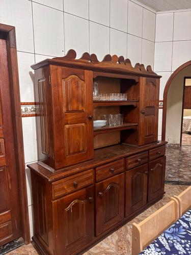 a large wooden cabinet in a room at Casa com Quartos compartilhados in Rio Branco