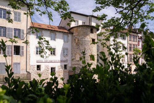 an old building with a tower behind some trees at Hôtel des Basses Pyrénées - Bayonne in Bayonne