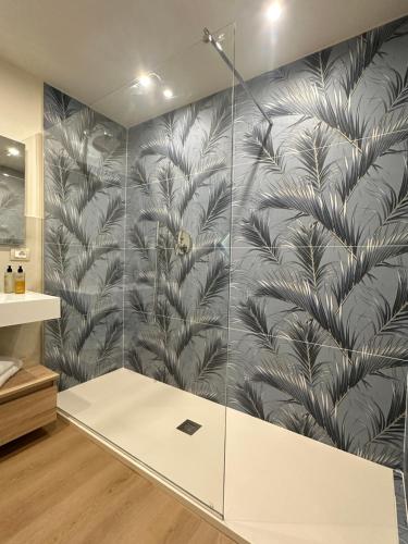 a shower in a bathroom with a wall of glass at ComfortHouse AlbatrosMare in Ladispoli