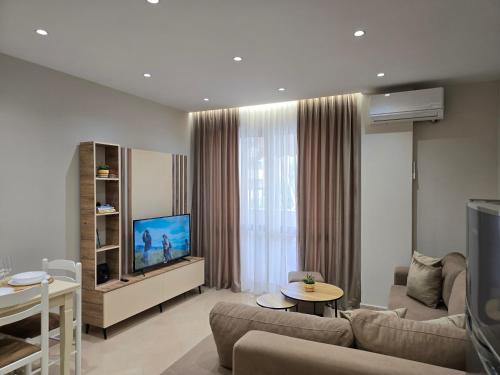 a living room with a couch and a tv at A&B Seaside Residence in Golem