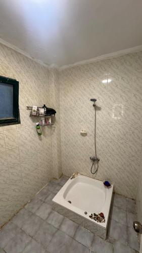 a bathroom with a bath tub in a room at Authentic Cozy Chalet Near the Beach in Ras Sedr