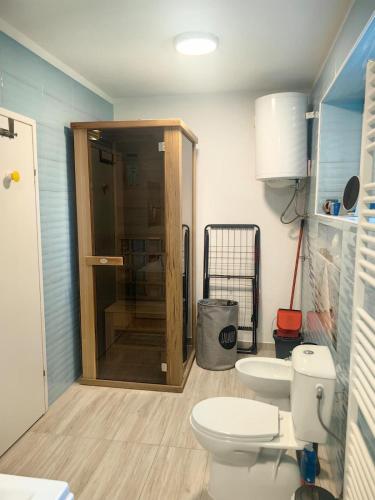 a bathroom with a toilet and a shower in it at Villa Mario Verde in Punat