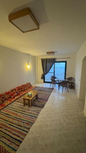 a living room with a couch and a table at Authentic Cozy Chalet Near the Beach in Ras Sedr