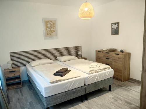 a bedroom with a large bed with a wooden headboard at Villa Mario Verde in Punat