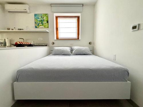 a white bedroom with a bed in a room at Ankaran Studio Escape in Ankaran