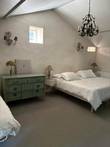a bedroom with a bed and a desk with a laptop at La croix des granges - le gîte in Chapdeuil