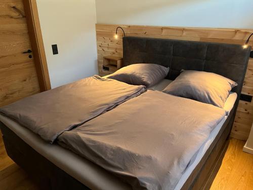 a bed with two pillows on it in a room at Ferienwohnung Heiterwang in Heiterwang