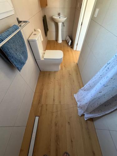 a small bathroom with a toilet and a sink at Tossal del Pla in Estivella