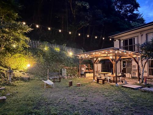 a garden at night with a pavilion and lights at Cruise garden in Kanō