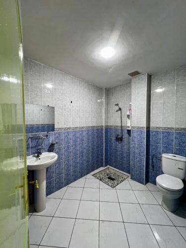 a bathroom with a toilet and a sink at Cozy Flat With Pool Near The Beach TAMRAGHT -APP13 in Tamraght Ouzdar