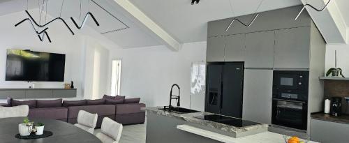 a living room with a couch and a fireplace at ОмниЯ Терас in Chernomorets