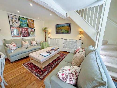 a living room with a couch and a table at Grange Cottage in Langham