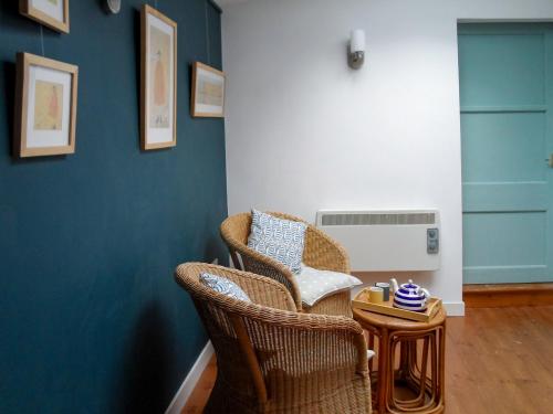 a living room with two chairs and a heater at Fisher Gallery in Pittenweem