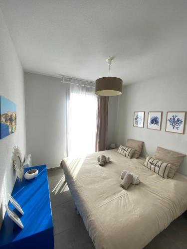 a bedroom with a large bed with two stuffed animals on it at Villa Léonie in Bonifacio