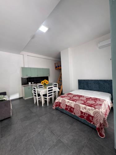 a bedroom with a bed and a table with chairs at Liza's apartment 1f in Skataj