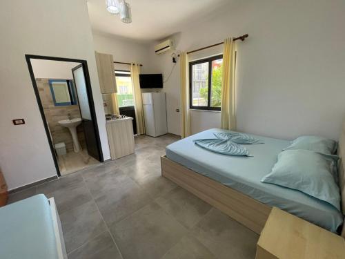 una camera da letto con un letto e un bagno con uno specchio di Vila Manuel a Shëngjin