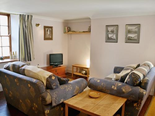 a living room with a couch and a table at Haven Cottage - E4342 in Holy Island