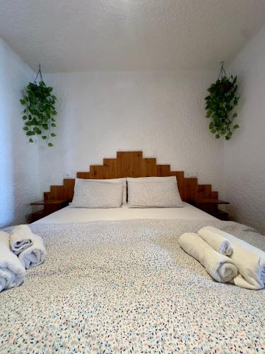 a bedroom with a bed with towels on it at Dimaro Apartment in Monclassico