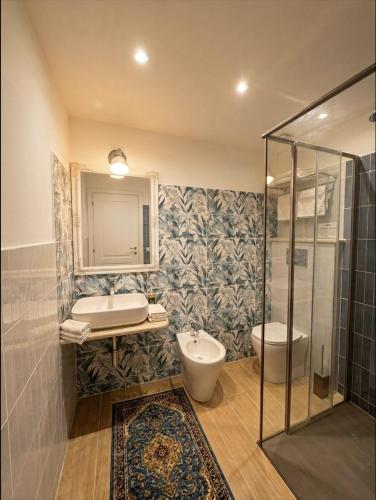 a bathroom with a shower and a sink and a toilet at BlueSkyLite in Taormina