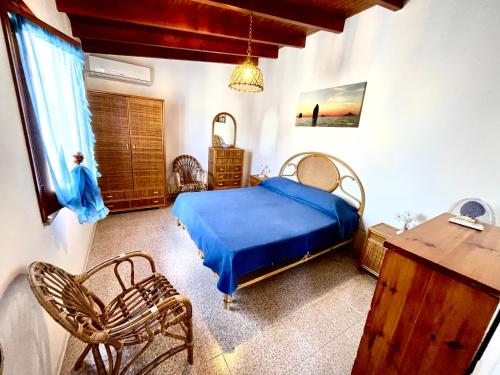 a bedroom with a bed and a table and chairs at CasaEolia Blues in Canneto
