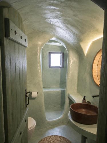 a bathroom with a sink and a toilet at Selora Cave in Pyrgos