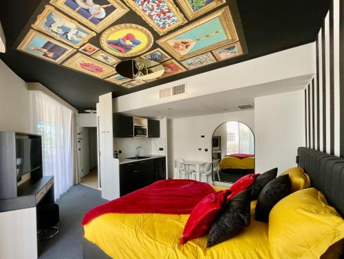 a bedroom with a large bed with a painted ceiling at Le Royal VIBES in Cap d'Agde