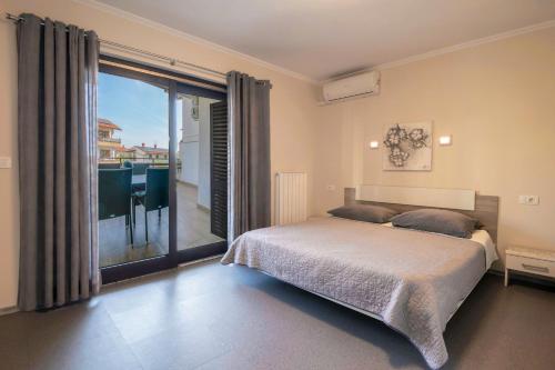 a bedroom with a bed and a large window at Prostorni in udobni apartmaji Izola SL - Spacious & Comfortable Apartments Izola SL in Izola
