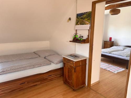 a small bedroom with a bed and a table at Apartmán Silvia in Komárno