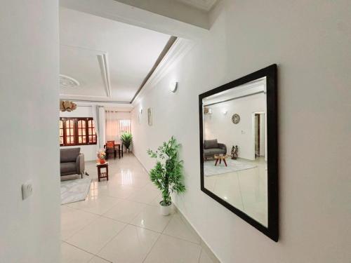 a mirror on a wall in a living room at Le nid des Anges in Yaoundé
