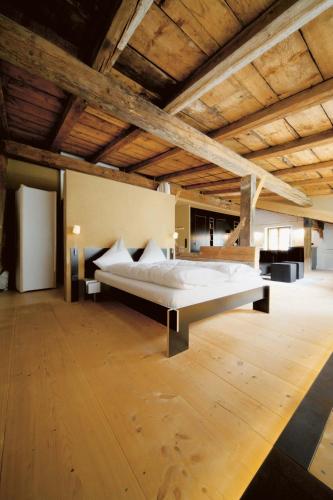 a large bedroom with a bed in the middle of a room at berge I Design-Quartiere in Aschau im Chiemgau
