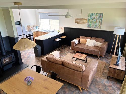 a living room with a couch and a table at Augusta Sheoak Chalets in Augusta