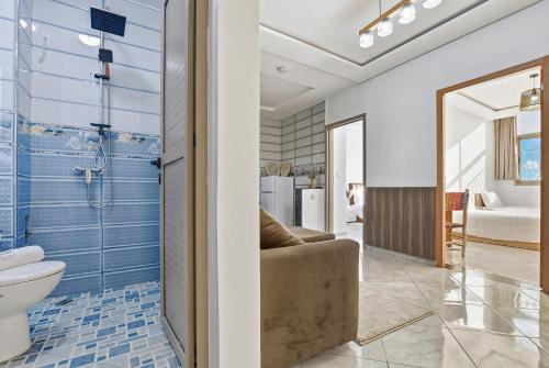 a bathroom with a couch and a toilet in a room at White Majorelle Horizon in Tamraght Ouzdar
