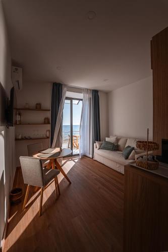 a living room with a couch and a table at 266 La Barraca in Torvaianica