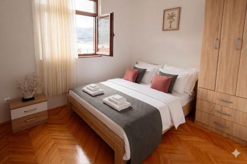 a bedroom with a bed with two towels on it at Sea Nook in Trstenik