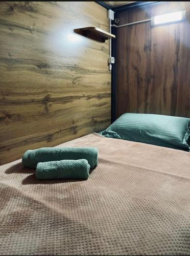 a bed with two pillows on top of it at Kochevnik capsule Hostel in Almaty