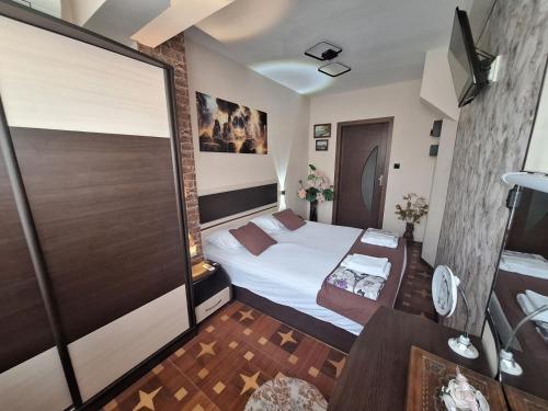a small room with a bed and a table at Lily Aparts in Varna City