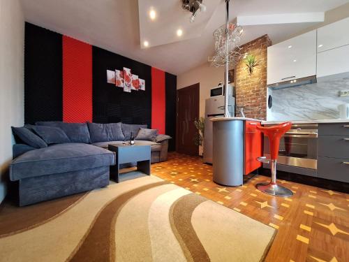 a living room with a couch and a kitchen at Lily Aparts in Varna City