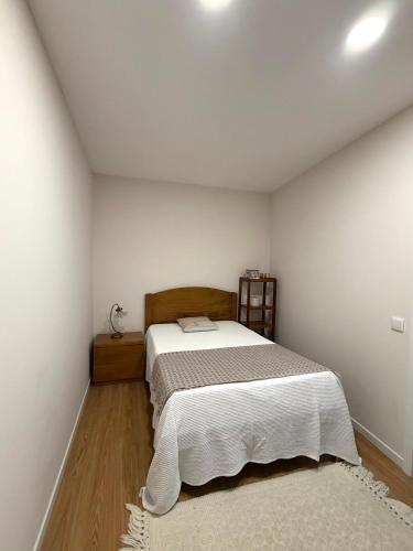 a bedroom with a bed in a white room at Casa da Linha in Caminha