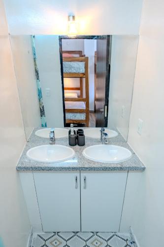a bathroom with two sinks and a mirror at Me Gusta Sucre Inn in Sucre