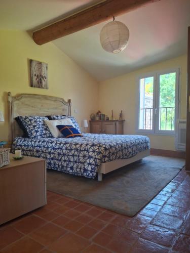 a bedroom with a bed and a window at Casa Doudou in Bédoin