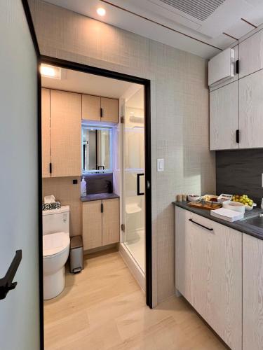 a bathroom with a sink and a toilet in a room at The Lake Villa in Ingramport