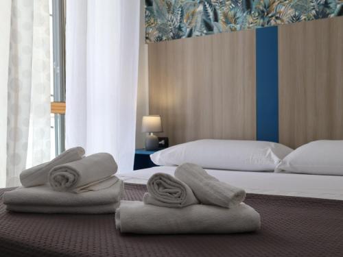 a hotel room with two beds with towels on them at Villa Flora in Pompei