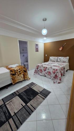a large room with two beds and a rug at Di Fronte Al Bosco in Santa Teresa