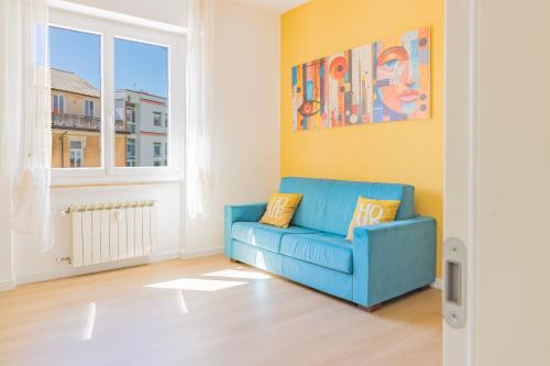 a blue couch in a room with a window at Psalm 23 in Savona