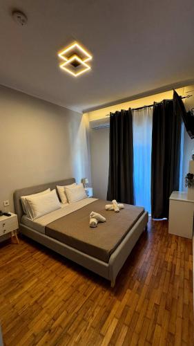 a large bed in a bedroom with a wooden floor at GiAngels in Chania