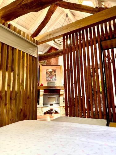 a room with a bed and a fireplace at CASA FOLIBAR-Encanto rural entre piedra y madera Valle del Silencio in Manzanedo de Valdueza