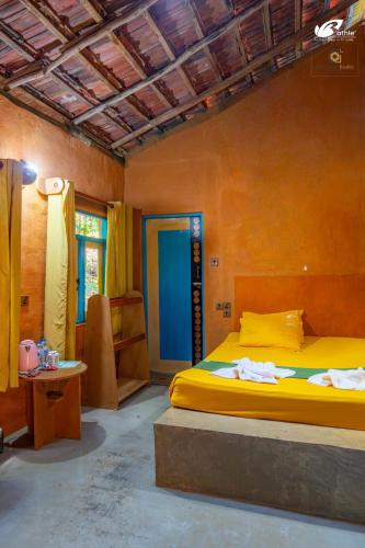 a bedroom with a large yellow bed in a room at Bathle Eco Resort in Mawanella